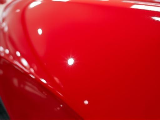 The same red car with a deep, reflective shine after polishing.